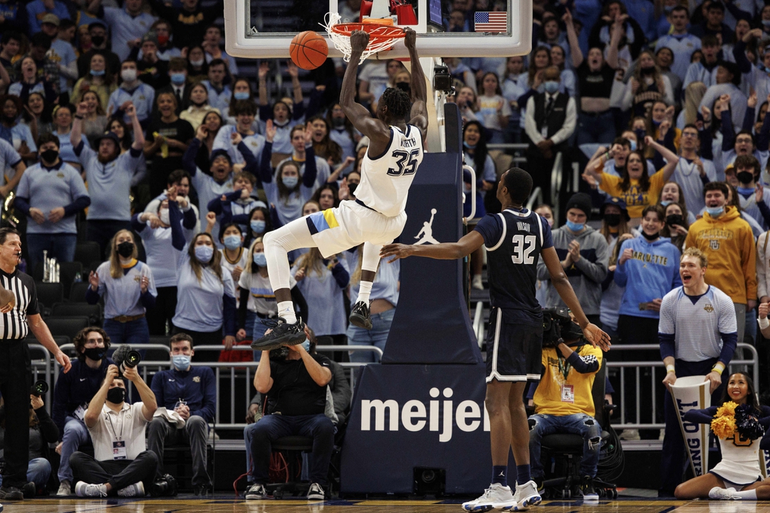 Feb 16, 2022; Milwaukee, Wisconsin, USA;  Marquette Golden Eagles forward Kur Kuath (35) dunks during the first half against the Georgetown Hoyas at Fiserv Forum. Mandatory Credit: Jeff Hanisch-USA TODAY Sports