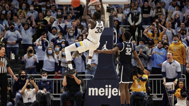 Feb 16, 2022; Milwaukee, Wisconsin, USA;  Marquette Golden Eagles forward Kur Kuath (35) dunks during the first half against the Georgetown Hoyas at Fiserv Forum. Mandatory Credit: Jeff Hanisch-USA TODAY Sports