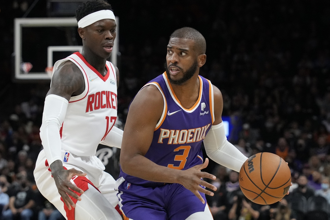 Feb 16, 2022; Phoenix, Arizona, USA; Phoenix Suns guard Chris Paul (3) drives past Houston Rockets guard Dennis Schroeder at Footprint Center. Mandatory Credit: Rick Scuteri-USA TODAY Sports