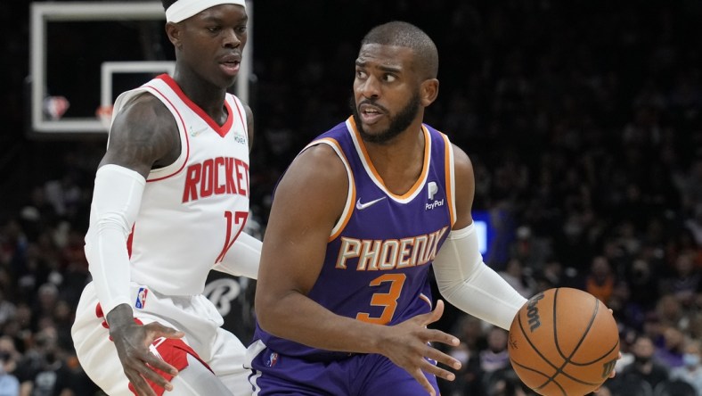 Feb 16, 2022; Phoenix, Arizona, USA; Phoenix Suns guard Chris Paul (3) drives past Houston Rockets guard Dennis Schroeder at Footprint Center. Mandatory Credit: Rick Scuteri-USA TODAY Sports