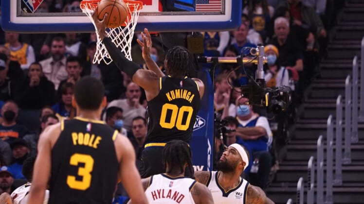 Feb 16, 2022; San Francisco, California, USA; Golden State Warriors forward Jonathan Kuminga (00) scores a basket above Denver Nuggets center DeMarcus Cousins (4) during the first quarter at Chase Center. Mandatory Credit: Kelley L Cox-USA TODAY Sports