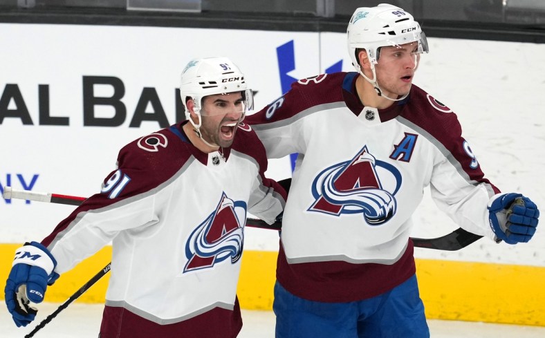 Feb 16, 2022; Las Vegas, Nevada, USA; Colorado Avalanche right wing Mikko Rantanen (96) celebrates with center Nazem Kadri (91) after scoring a power-play goal against the Vegas Golden Knights during the third period at T-Mobile Arena. Mandatory Credit: Stephen R. Sylvanie-USA TODAY Sports