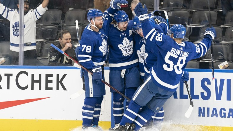 Feb 17, 2022; Toronto, Ontario, CAN; Toronto  Maple Leafs center Auston Matthews (34) celebrates scoring a goal with Toronto Maple Leafs left wing Michael Bunting (58) during the first period against the Pittsburgh Penguins at Scotiabank Arena. Mandatory Credit: Nick Turchiaro-USA TODAY Sports