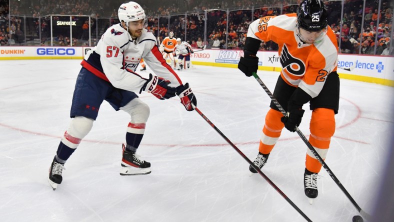 Feb 17, 2022; Philadelphia, Pennsylvania, USA; Washington Capitals defenseman Trevor van Riemsdyk (57) and Philadelphia Flyers left wing James van Riemsdyk (25) battle for the puck during the first period at Wells Fargo Center. Mandatory Credit: Eric Hartline-USA TODAY Sports