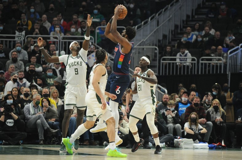 Feb 17, 2022; Milwaukee, Wisconsin, USA;  Philadelphia 76ers center Joel Embiid (21) puts up a shot against Milwaukee Bucks center Bobby Portis (9) in the first quarter at Fiserv Forum. Mandatory Credit: Michael McLoone-USA TODAY Sports