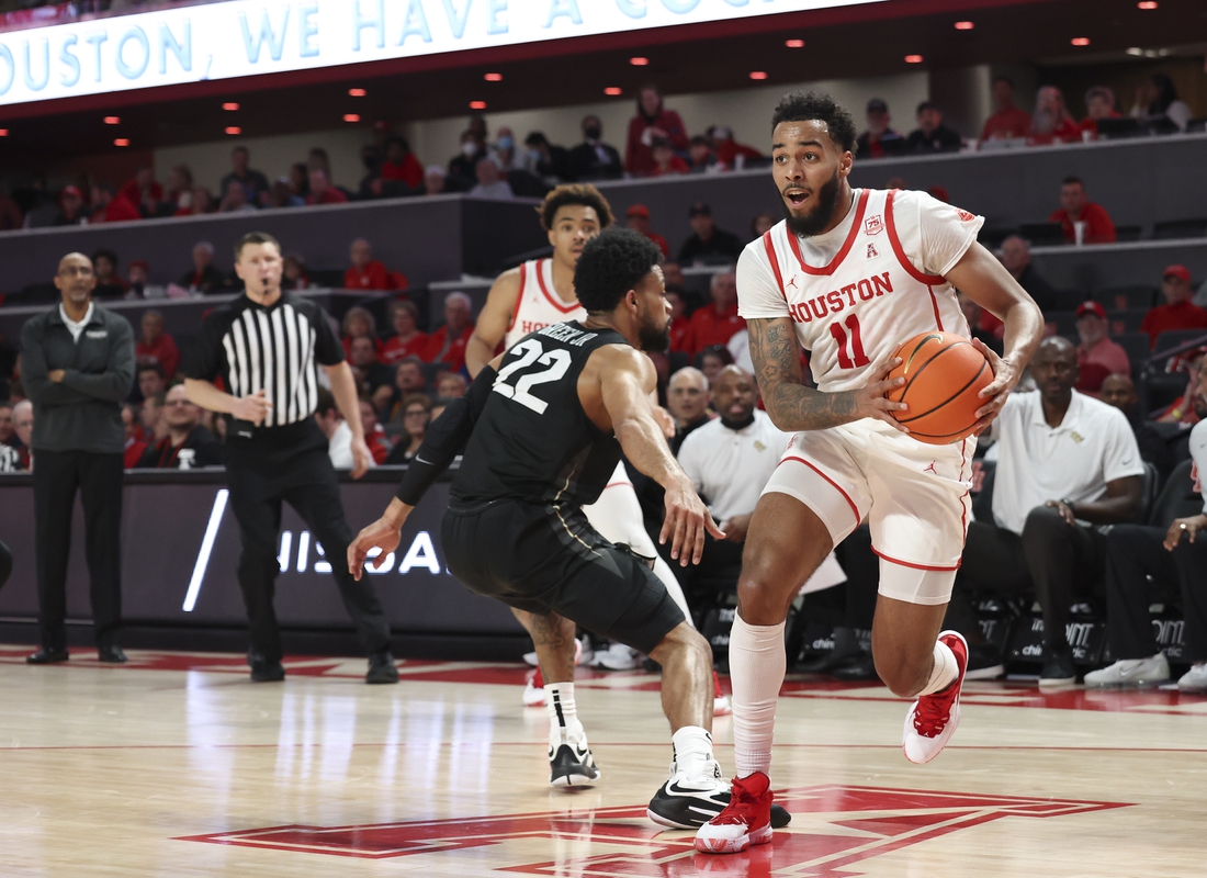 Feb 17, 2022; Houston, Texas, USA; Houston Cougars guard Kyler Edwards (11) dribbles against UCF Knights guard Darin Green Jr. (22) in the first half at Fertitta Center.  Mandatory Credit: Thomas Shea-USA TODAY Sports