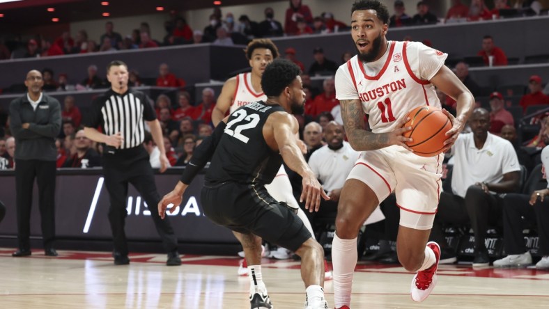 Feb 17, 2022; Houston, Texas, USA; Houston Cougars guard Kyler Edwards (11) dribbles against UCF Knights guard Darin Green Jr. (22) in the first half at Fertitta Center.  Mandatory Credit: Thomas Shea-USA TODAY Sports