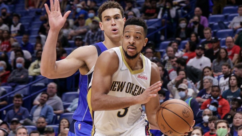 Feb 17, 2022; New Orleans, Louisiana, USA;  New Orleans Pelicans guard CJ McCollum (3) dribbles against Dallas Mavericks center Dwight Powell (7) during the second half at the Smoothie King Center. Mandatory Credit: Stephen Lew-USA TODAY Sports