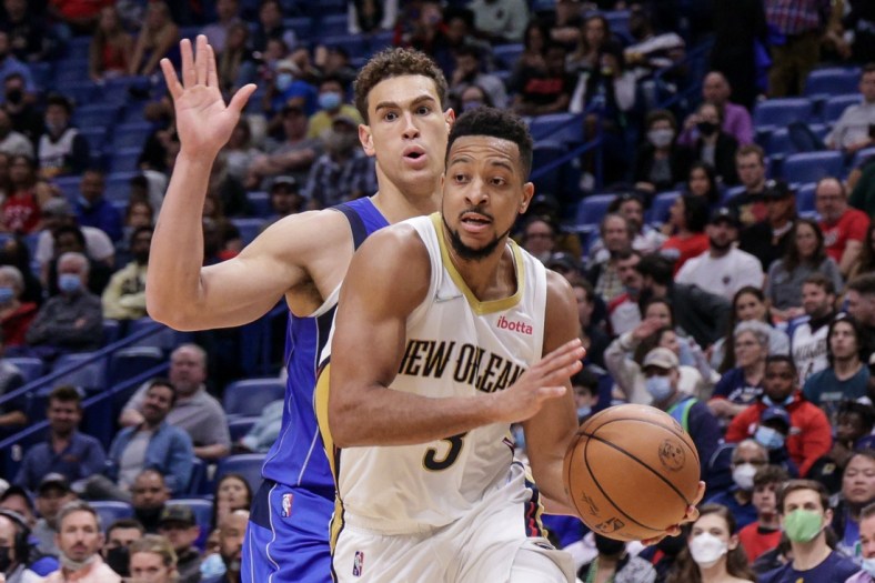 Feb 17, 2022; New Orleans, Louisiana, USA;  New Orleans Pelicans guard CJ McCollum (3) dribbles against Dallas Mavericks center Dwight Powell (7) during the second half at the Smoothie King Center. Mandatory Credit: Stephen Lew-USA TODAY Sports