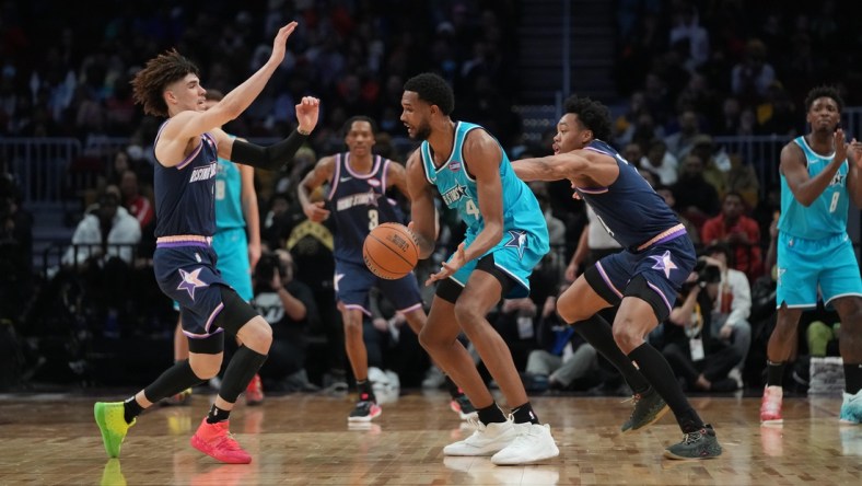 Feb 18, 2022; Cleveland, Ohio, USA; Team Barry forward Evan Mobley (4) is defended by Team Payton guard LaMelo Ball (2) during the 2022 NBA Rising Stars Challenge at Rocket Mortgage Fieldhouse. Mandatory Credit: Kyle Terada-USA TODAY Sports