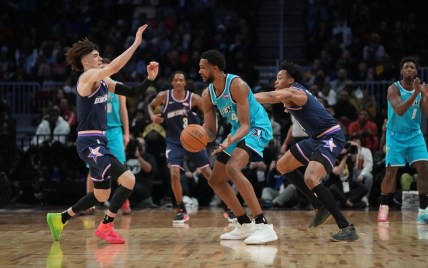 Feb 18, 2022; Cleveland, Ohio, USA; Team Barry forward Evan Mobley (4) is defended by Team Payton guard LaMelo Ball (2) during the 2022 NBA Rising Stars Challenge at Rocket Mortgage Fieldhouse. Mandatory Credit: Kyle Terada-USA TODAY Sports
