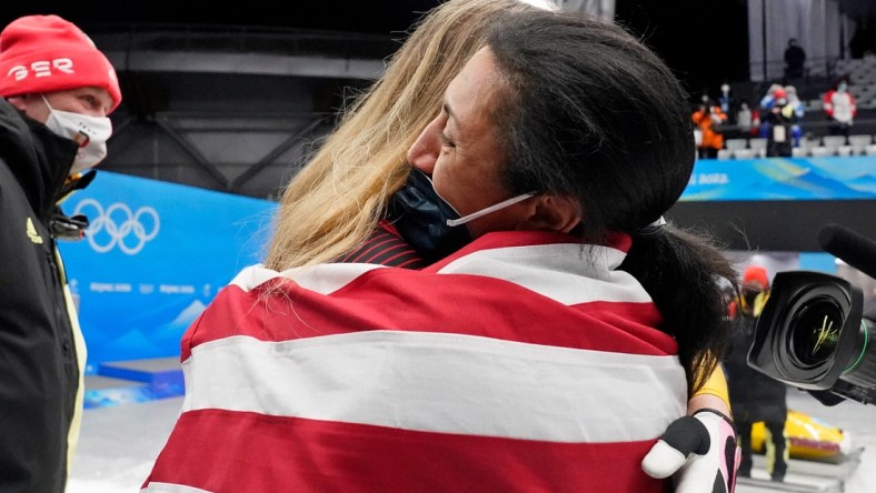 Feb 19, 2022; Yanqing, China; Laura Nolte (GER) hugs Elana Meyers Taylor (USA) after the 2-woman bobsleigh during the Beijing 2022 Olympic Winter Games at Yanqing Sliding Centre. Mandatory Credit: Harrison Hill-USA TODAY Sports