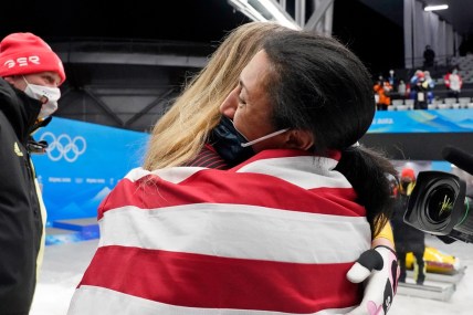 Feb 19, 2022; Yanqing, China; Laura Nolte (GER) hugs Elana Meyers Taylor (USA) after the 2-woman bobsleigh during the Beijing 2022 Olympic Winter Games at Yanqing Sliding Centre. Mandatory Credit: Harrison Hill-USA TODAY Sports