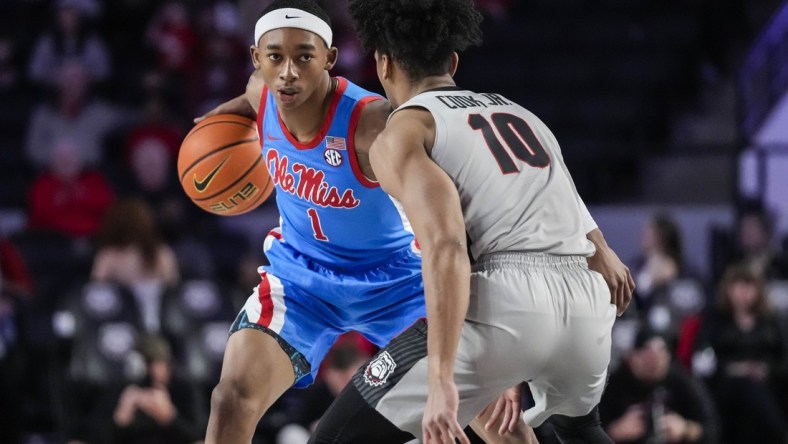 Feb 19, 2022; Athens, Georgia, USA; Mississippi Rebels guard Austin Crowley (1) dribbles against Georgia Bulldogs guard Aaron Cook (10) during the first half at Stegeman Coliseum. Mandatory Credit: Dale Zanine-USA TODAY Sports