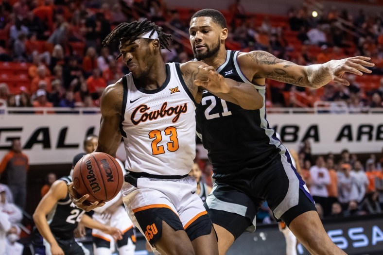 Feb 19, 2022; Stillwater, Oklahoma, USA; Oklahoma State Cowboys forward Tyreek Smith (23) moves the ball while defended by Kansas State Wildcats forward Davion Bradford (21) during the first half at Gallagher-Iba Arena. Mandatory Credit: Rob Ferguson-USA TODAY Sports
