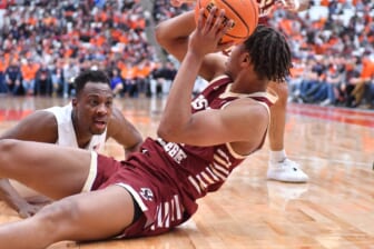 Feb 19, 2022; Syracuse, New York, USA; Syracuse Orange center Bourama Sidibe (left) reacts to Boston College Eagles forward Gianni Thompson (24) gaining control of a loose ball in the second half at the Carrier Dome. Mandatory Credit: Mark Konezny-USA TODAY Sports