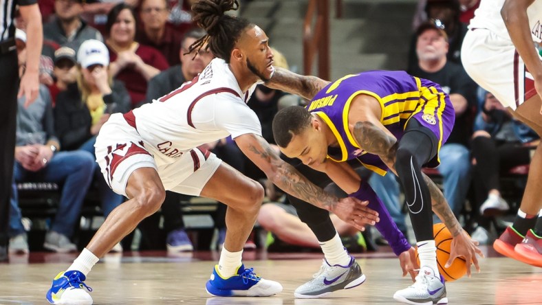 Feb 19, 2022; Columbia, South Carolina, USA; South Carolina Gamecocks guard James Reese V (0) and LSU Tigers guard Xavier Pinson (1) battle for a loose ball in the first half at Colonial Life Arena. Mandatory Credit: Jeff Blake-USA TODAY Sports