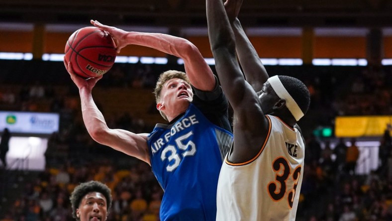 Feb 19, 2022; Laramie, Wyoming, USA; Air Force Falcons center Lucas Moerman (35) shoots against Wyoming Cowboys forward Graham Ike (33) during the first half at Arena-Auditorium. Mandatory Credit: Troy Babbitt-USA TODAY Sports