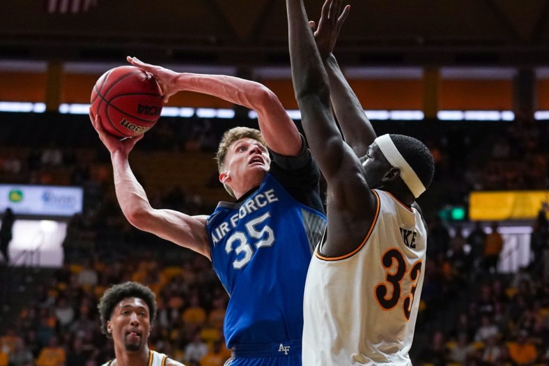 Feb 19, 2022; Laramie, Wyoming, USA; Air Force Falcons center Lucas Moerman (35) shoots against Wyoming Cowboys forward Graham Ike (33) during the first half at Arena-Auditorium. Mandatory Credit: Troy Babbitt-USA TODAY Sports