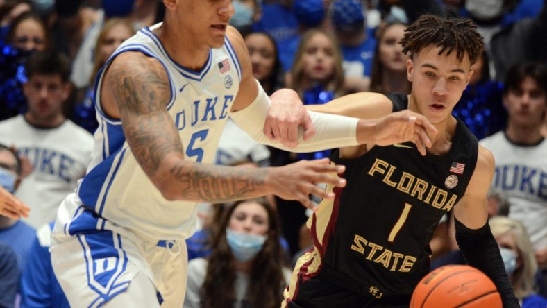 Feb 19, 2022; Durham, North Carolina, USA; Duke Blue Devils forward Paolo Banchero (5) and Florida State Seminoles guard Jalen Warley (1) fight for a loose ball during the first half at Cameron Indoor Stadium. Mandatory Credit: Rob Kinnan-USA TODAY Sports