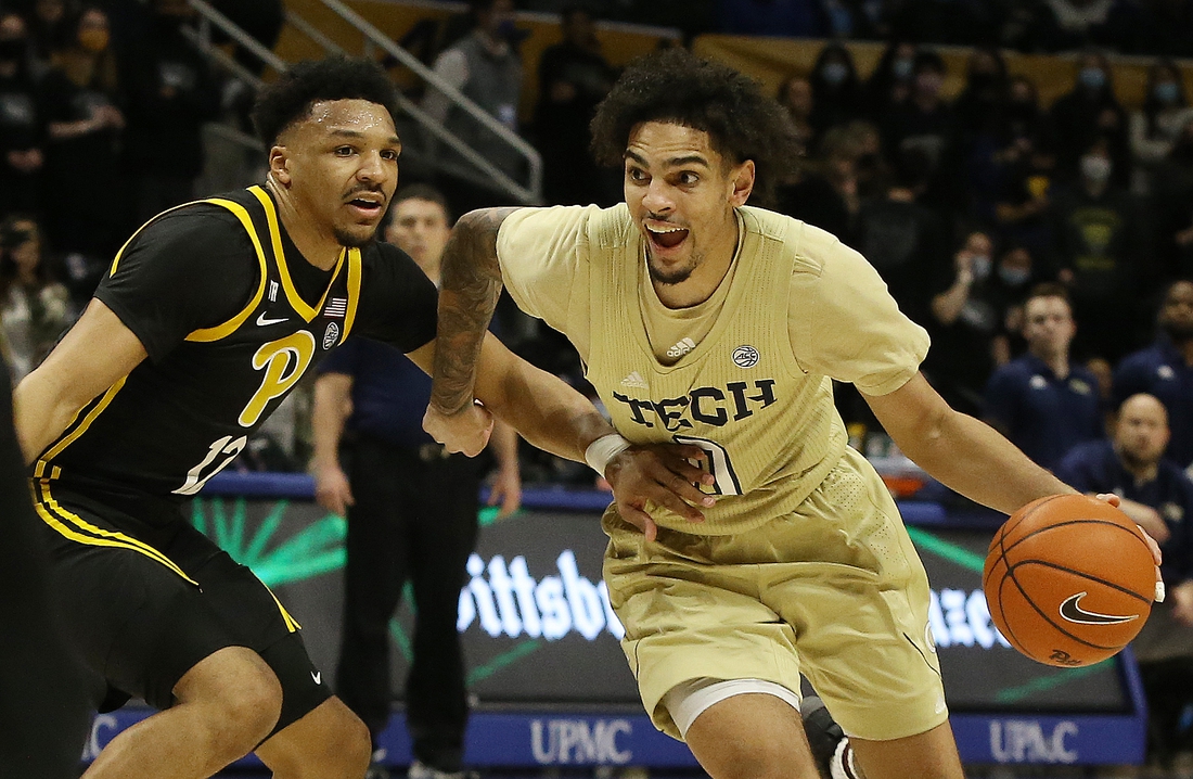 Feb 19, 2022; Pittsburgh, Pennsylvania, USA;  Georgia Tech Yellow Jackets guard Michael Devoe (0) dribbles the ball against Pittsburgh Panthers guard Ithiel Horton (12) during the first half at the Petersen Events Center. Mandatory Credit: Charles LeClaire-USA TODAY Sports