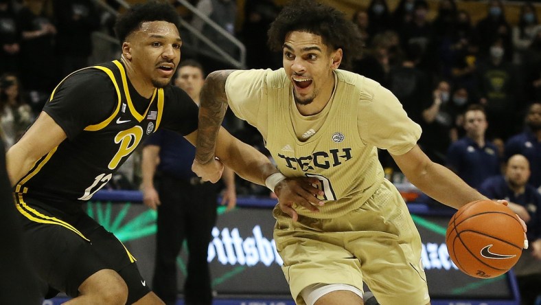 Feb 19, 2022; Pittsburgh, Pennsylvania, USA;  Georgia Tech Yellow Jackets guard Michael Devoe (0) dribbles the ball against Pittsburgh Panthers guard Ithiel Horton (12) during the first half at the Petersen Events Center. Mandatory Credit: Charles LeClaire-USA TODAY Sports