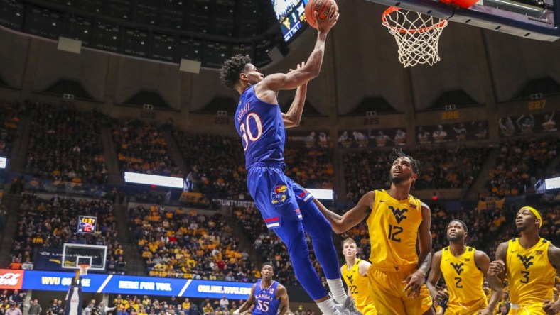 Feb 19, 2022; Morgantown, West Virginia, USA; Kansas Jayhawks guard Ochai Agbaji (30) shoots along the baseline during the first half against the West Virginia Mountaineers at WVU Coliseum. Mandatory Credit: Ben Queen-USA TODAY Sports