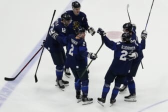 Feb 20, 2022; Beijing, China; Team Finland forward Hannes Bjorninen (24) celebrates with teammates after scoring a goal against Team ROC in the third period during the Beijing 2022 Olympic Winter Games at National Indoor Stadium. Mandatory Credit: George Walker IV-USA TODAY Sports