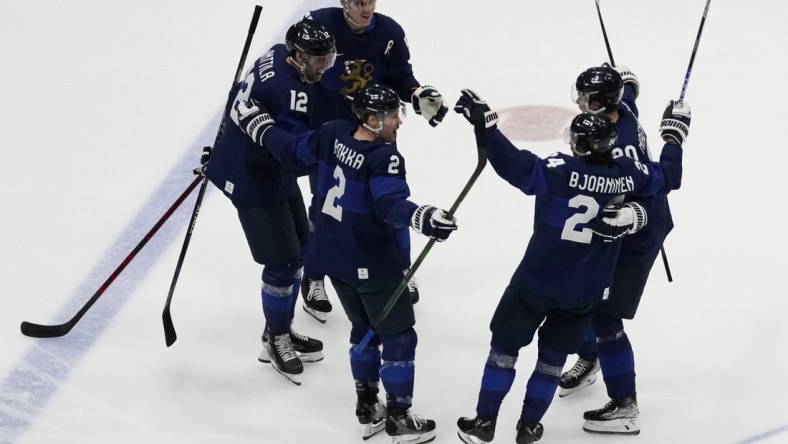 Feb 20, 2022; Beijing, China; Team Finland forward Hannes Bjorninen (24) celebrates with teammates after scoring a goal against Team ROC in the third period during the Beijing 2022 Olympic Winter Games at National Indoor Stadium. Mandatory Credit: George Walker IV-USA TODAY Sports