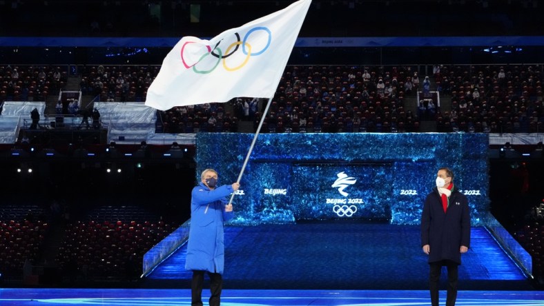 Feb 20, 2022; Beijing, CHINA; IOC president Thomas Bach waves the Olympic flag during the closing ceremony for the Beijing 2022 Olympic Winter Games at Beijing National Stadium. Mandatory Credit: Rob Schumacher-USA TODAY Sports