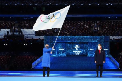 Feb 20, 2022; Beijing, CHINA; IOC president Thomas Bach waves the Olympic flag during the closing ceremony for the Beijing 2022 Olympic Winter Games at Beijing National Stadium. Mandatory Credit: Rob Schumacher-USA TODAY Sports