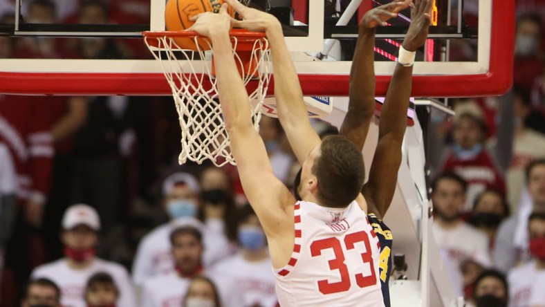 Feb 20, 2022; Madison, Wisconsin, USA; Wisconsin Badgers center Chris Vogt (33) dunks the ball in the game with the Michigan Wolverines at the Kohl Center. Mandatory Credit: Mary Langenfeld-USA TODAY Sports