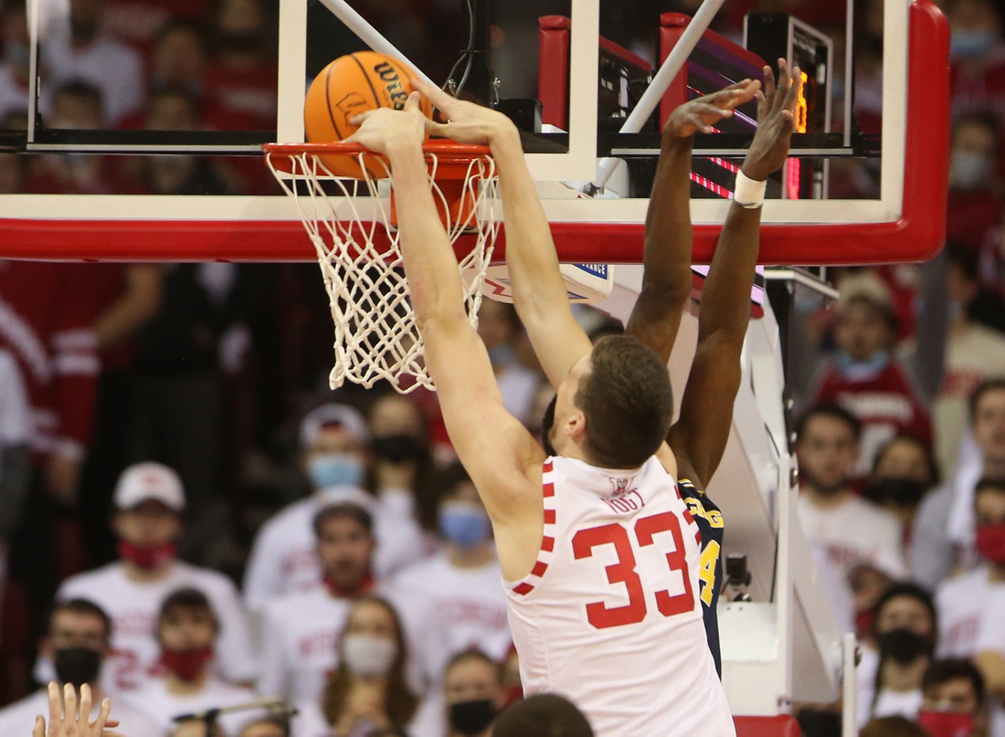 Feb 20, 2022; Madison, Wisconsin, USA; Wisconsin Badgers center Chris Vogt (33) dunks the ball in the game with the Michigan Wolverines at the Kohl Center. Mandatory Credit: Mary Langenfeld-USA TODAY Sports