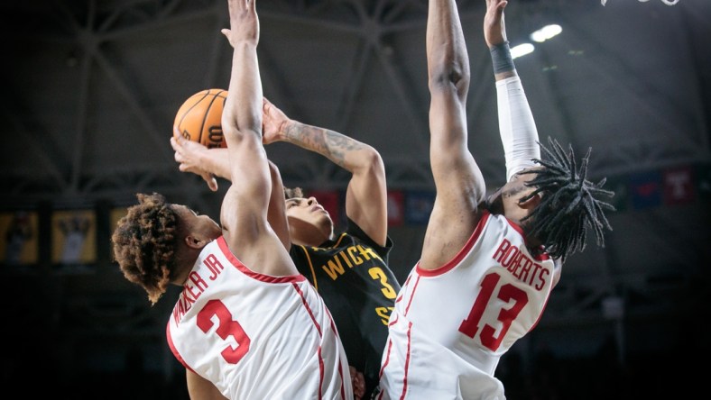 Feb 20, 2022; Wichita, Kansas, USA; Wichita State Shockers guard Craig Porter Jr. (3) tries to put up a shot over Houston Cougars guard Ramon Walker Jr. (3) and Houston Cougars forward J'Wan Roberts (13) during double overtime at Charles Koch Arena. Mandatory Credit: William Purnell-USA TODAY Sports