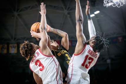 Feb 20, 2022; Wichita, Kansas, USA; Wichita State Shockers guard Craig Porter Jr. (3) tries to put up a shot over Houston Cougars guard Ramon Walker Jr. (3) and Houston Cougars forward J'Wan Roberts (13) during double overtime at Charles Koch Arena. Mandatory Credit: William Purnell-USA TODAY Sports