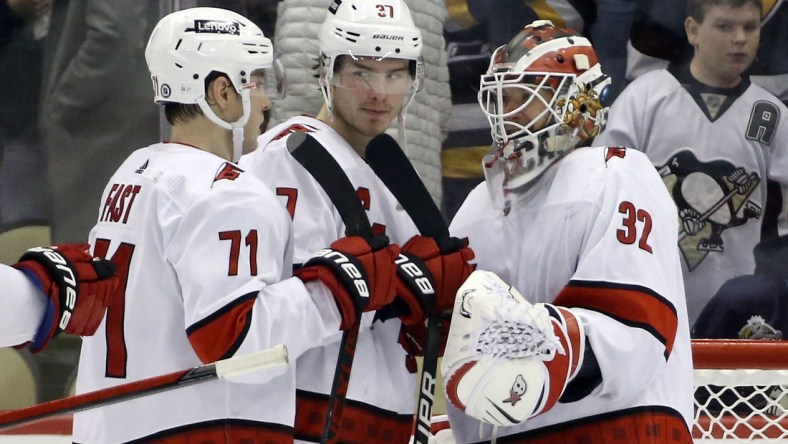 Feb 20, 2022; Pittsburgh, Pennsylvania, USA;  Carolina Hurricanes right wing Jesper Fast (71) and right wing Andrei Svechnikov (37) and goaltender Antti Raanta (32) celebrate after defeating the Pittsburgh Penguins at PPG Paints Arena. Carolina won 4-3. Mandatory Credit: Charles LeClaire-USA TODAY Sports