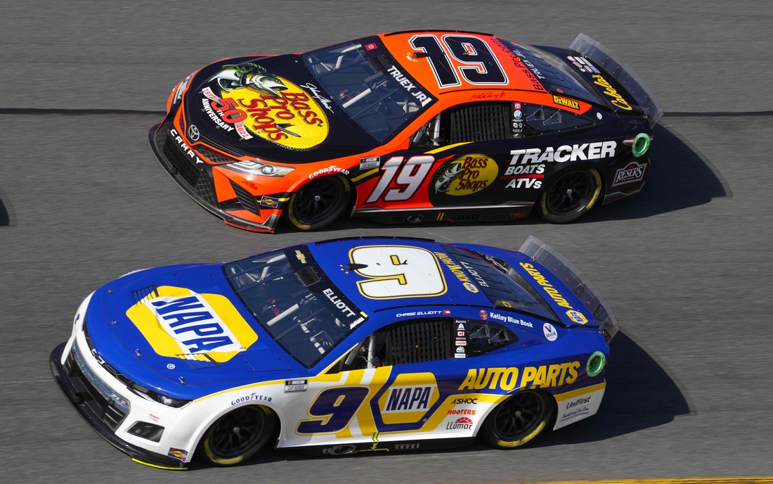 Feb 20, 2022; Daytona Beach, Florida, USA; NASCAR Cup Series driver Martin Truex Jr. (19) and driver Chase Elliott (9) race side by side during the Daytona 500 at Daytona International Speedway. Mandatory Credit: Mike Dinovo-USA TODAY Sports