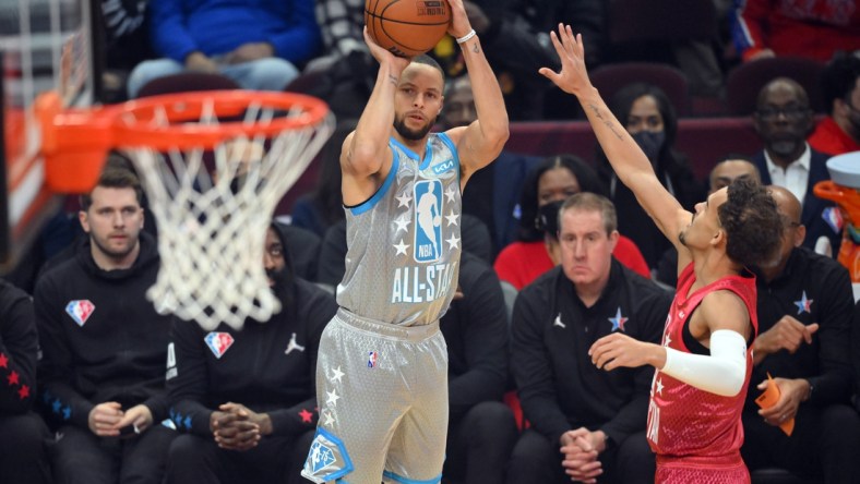 Feb 20, 2022; Cleveland, Ohio, USA; Team LeBron guard Stephen Curry (30) shoots a three point basket against Team Durant guard Trae Young (11) in the first quarter during the 2022 NBA All-Star Game at Rocket Mortgage FieldHouse. Mandatory Credit: David Richard-USA TODAY Sports