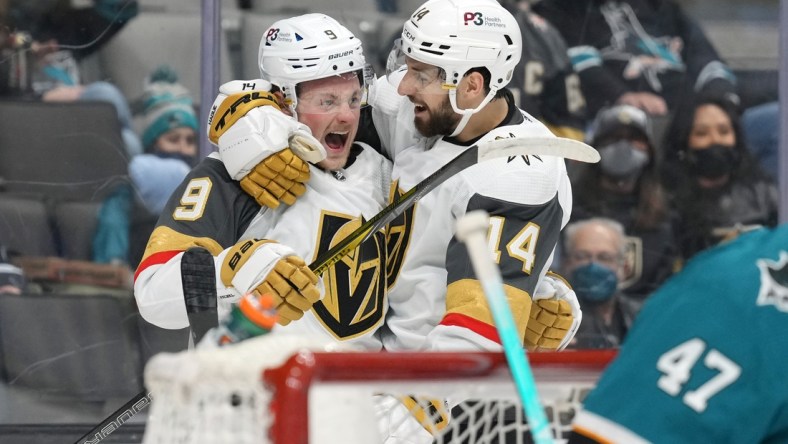 Feb 20, 2022; San Jose, California, USA; Vegas Golden Knights center Jack Eichel (9) celebrates with defenseman Nicolas Hague (14) after scoring a goal during the first period against the San Jose Sharks at SAP Center at San Jose. Mandatory Credit: Darren Yamashita-USA TODAY Sports