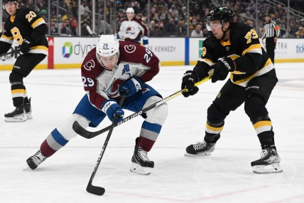 Feb 21, 2022; Boston, Massachusetts, USA; Boston Bruins defenseman Charlie McAvoy (73) defends Colorado Avalanche center Nathan MacKinnon (29) during the second period at the TD Garden. Mandatory Credit: Brian Fluharty-USA TODAY Sports