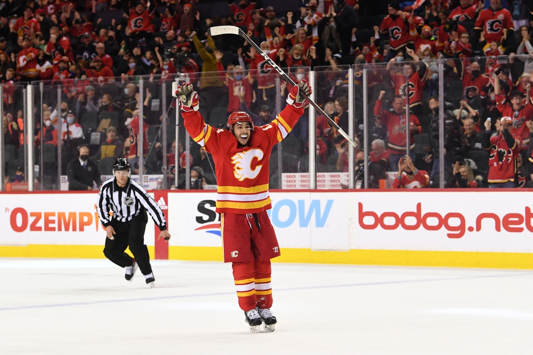 Feb 21, 2022; Calgary, Alberta, CAN; Calgary Flames forward Johnny Gaudreau (13) celebrates the game winning goal by forward Elias Lindholm (28)(not pictured) against the Winnipeg Jets in the third period at Scotiabank Saddledome. Flames won 3-1. Mandatory Credit: Candice Ward-USA TODAY Sports