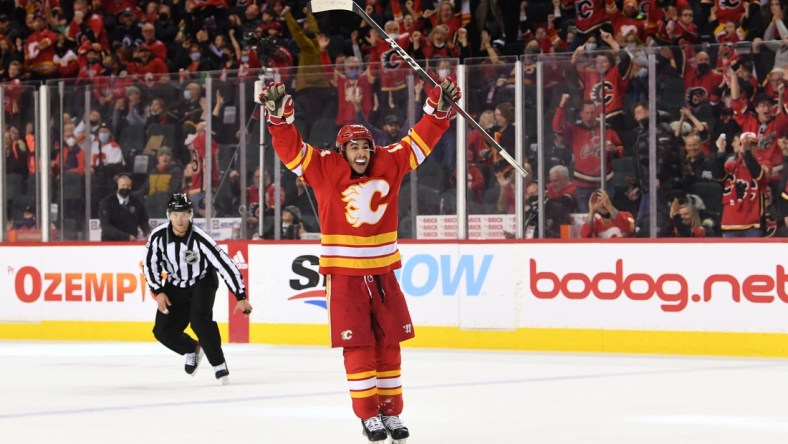 Feb 21, 2022; Calgary, Alberta, CAN; Calgary Flames forward Johnny Gaudreau (13) celebrates the game winning goal by forward Elias Lindholm (28)(not pictured) against the Winnipeg Jets in the third period at Scotiabank Saddledome. Flames won 3-1. Mandatory Credit: Candice Ward-USA TODAY Sports