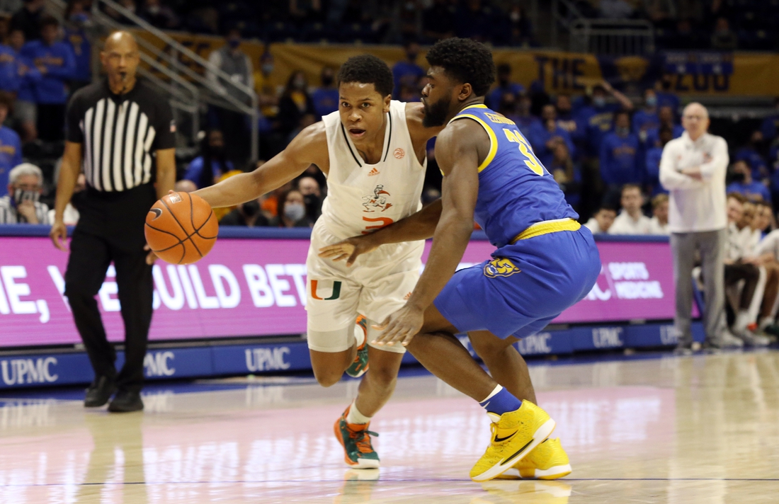 Feb 22, 2022; Pittsburgh, Pennsylvania, USA; Miami (Fl) Hurricanes guard Charlie Moore (3) dribbles the ball against Pittsburgh Panthers guard Onyebuchi Ezeakudo (31) during the first half at the Petersen Events Center. Mandatory Credit: Charles LeClaire-USA TODAY Sports