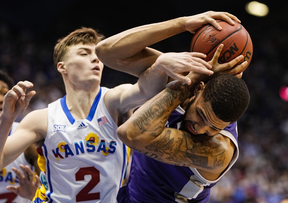 Feb 22, 2022; Lawrence, Kansas, USA; Kansas State Wildcats guard Markquis Nowell (1) grabs a rebound against Kansas Jayhawks guard Christian Braun (2) during the first half at Allen Fieldhouse. Mandatory Credit: Jay Biggerstaff-USA TODAY Sports