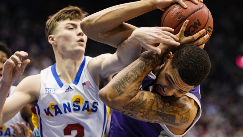 Feb 22, 2022; Lawrence, Kansas, USA; Kansas State Wildcats guard Markquis Nowell (1) grabs a rebound against Kansas Jayhawks guard Christian Braun (2) during the first half at Allen Fieldhouse. Mandatory Credit: Jay Biggerstaff-USA TODAY Sports