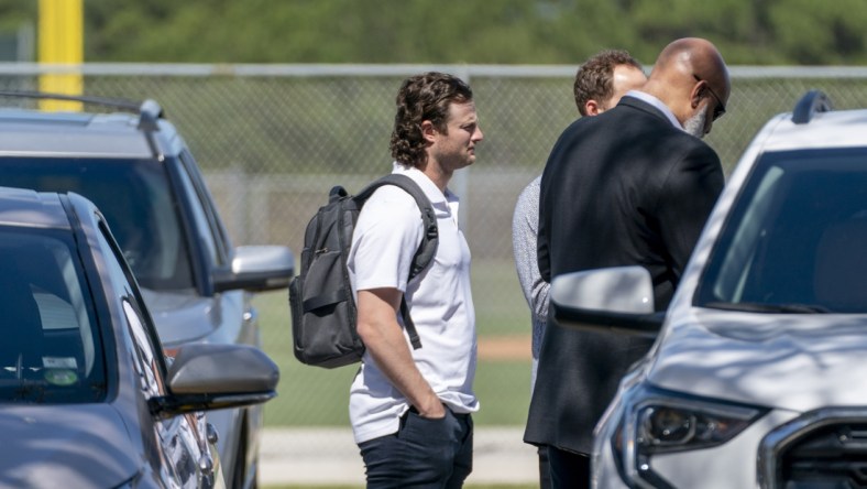 Feb 23, 2022; Jupiter, FL, USA;  New York Yankees pitcher Gerrit Cole, center, arrives for MLB contract negotiations at Roger Dean Stadium in Jupiter, Florida on February 23, 2022.   Mandatory Credit: Greg Lovett-USA TODAY NETWORK