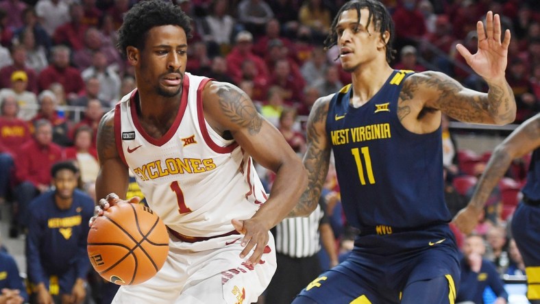 Iowa State Cyclones guard Izaiah Brockington (1) drives to the basket around West Virginia Mountaineers forward Pauly Paulicap (1) during the first half at Hilton Coliseum Wednesday, Feb. 23, 2022, in Ames, Iowa.