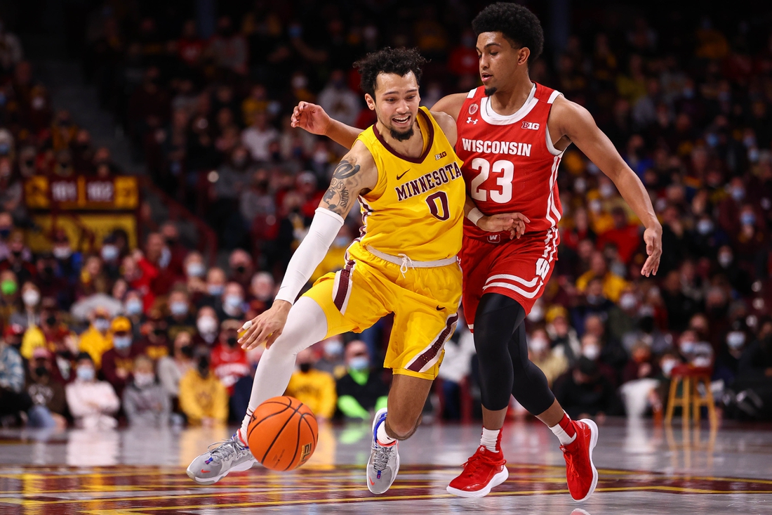 Feb 23, 2022; Minneapolis, Minnesota, USA; Minnesota Gophers guard Payton Willis (0) drives to the basket as Wisconsin Badgers guard Chucky Hepburn (23) guards him during the first half at Williams Arena. Mandatory Credit: Harrison Barden-USA TODAY Sports