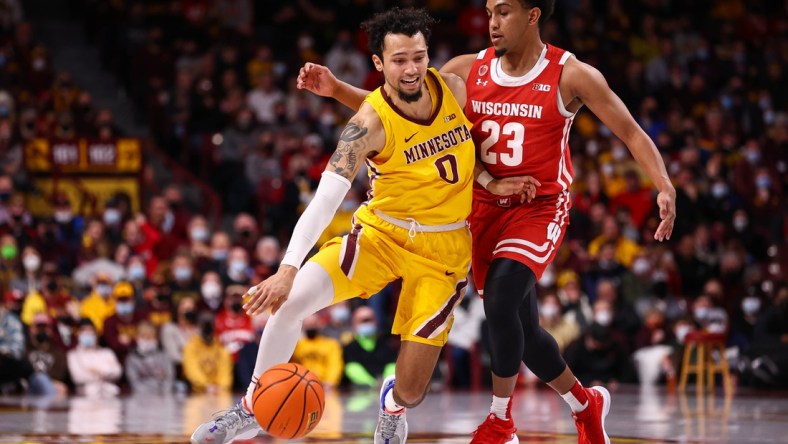 Feb 23, 2022; Minneapolis, Minnesota, USA; Minnesota Gophers guard Payton Willis (0) drives to the basket as Wisconsin Badgers guard Chucky Hepburn (23) guards him during the first half at Williams Arena. Mandatory Credit: Harrison Barden-USA TODAY Sports