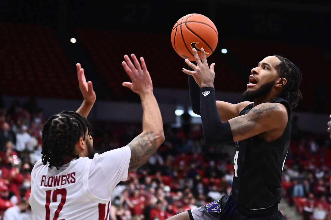 Feb 23, 2022; Pullman, Washington, USA; Washington Huskies guard PJ Fuller (4) shoots the ball against Washington State Cougars guard Michael Flowers (12) in the first half at Friel Court at Beasley Coliseum. Mandatory Credit: James Snook-USA TODAY Sports